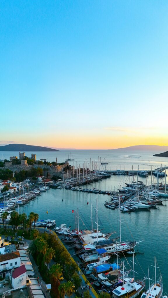 BODRUM – PRIVATE TOUR PROGRAMS Scenic sunset over Bodrum Marina with yachts and castle on Turkey